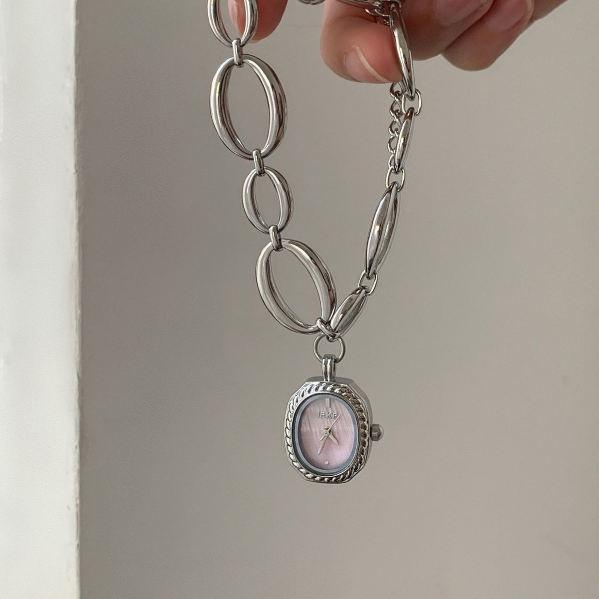 IEKE silver-tone oval-link bracelet watch with pink dial