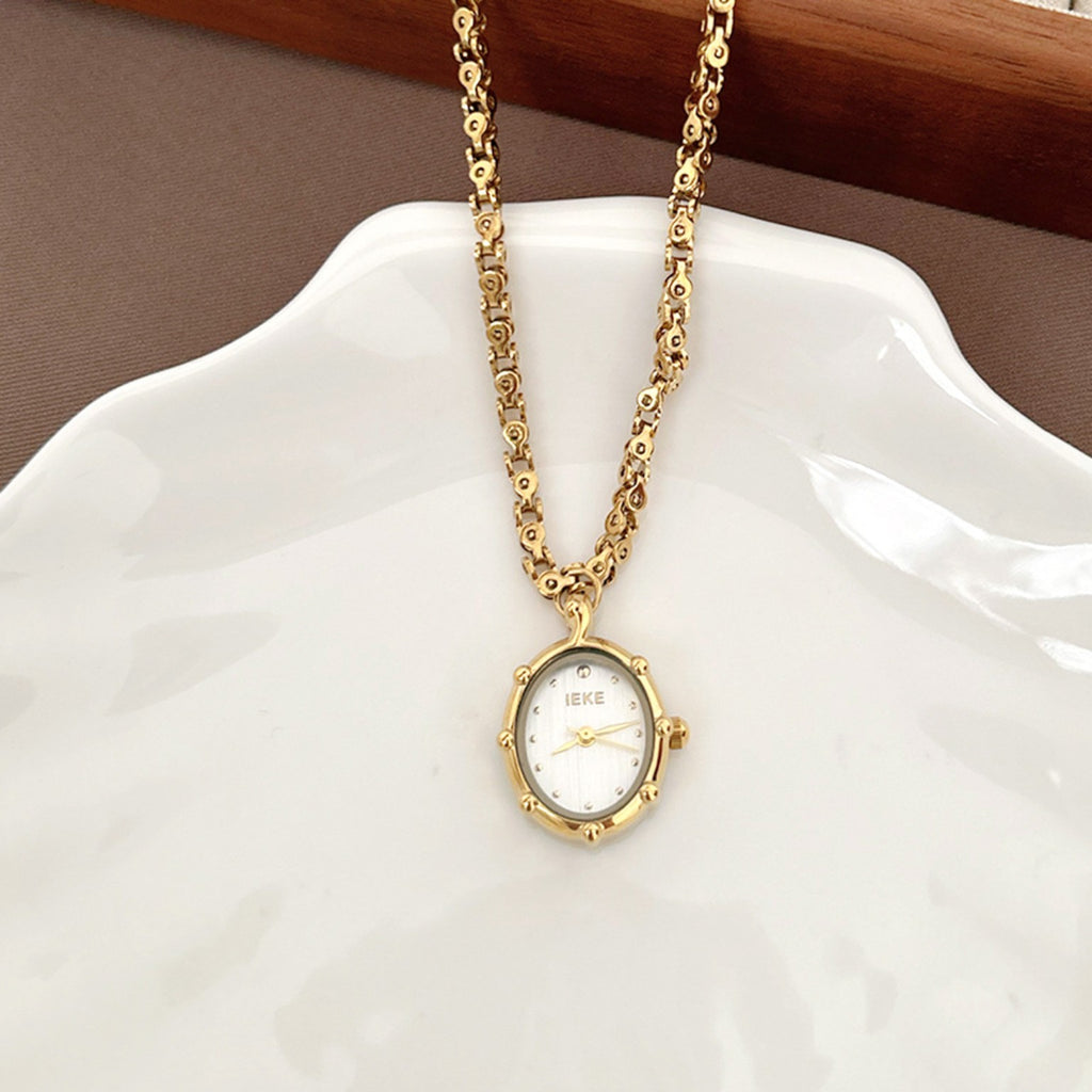 IEKE gold pendant necklace watch with white dial on ceramic tray