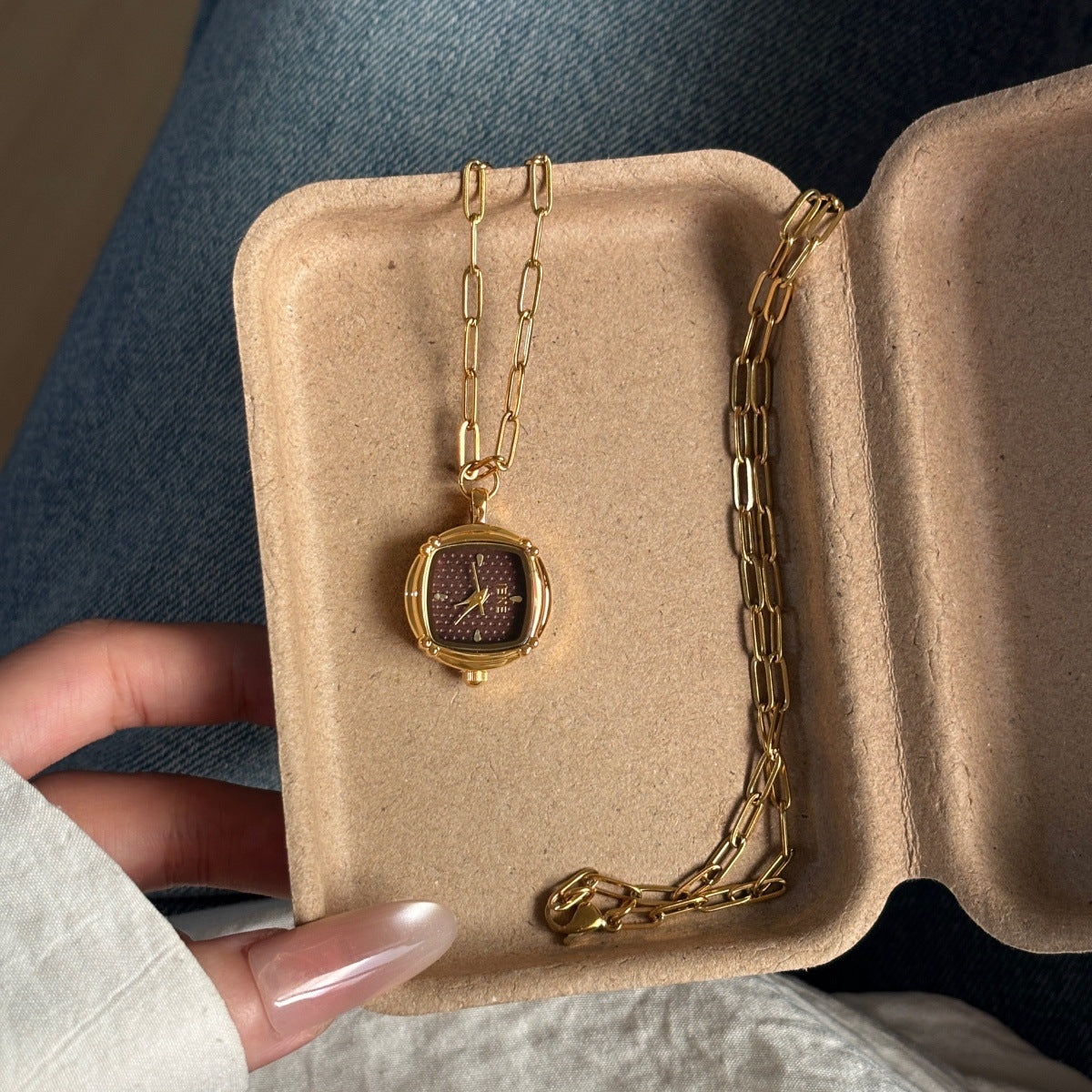 IEKE gold-tone pendant watch burgundy dial detail