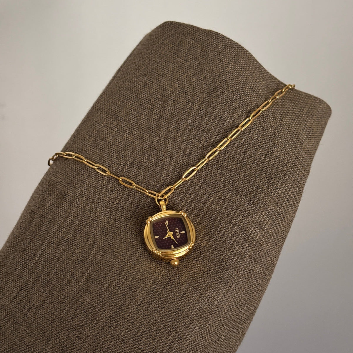 IEKE gold-tone pendant watch with burgundy dial