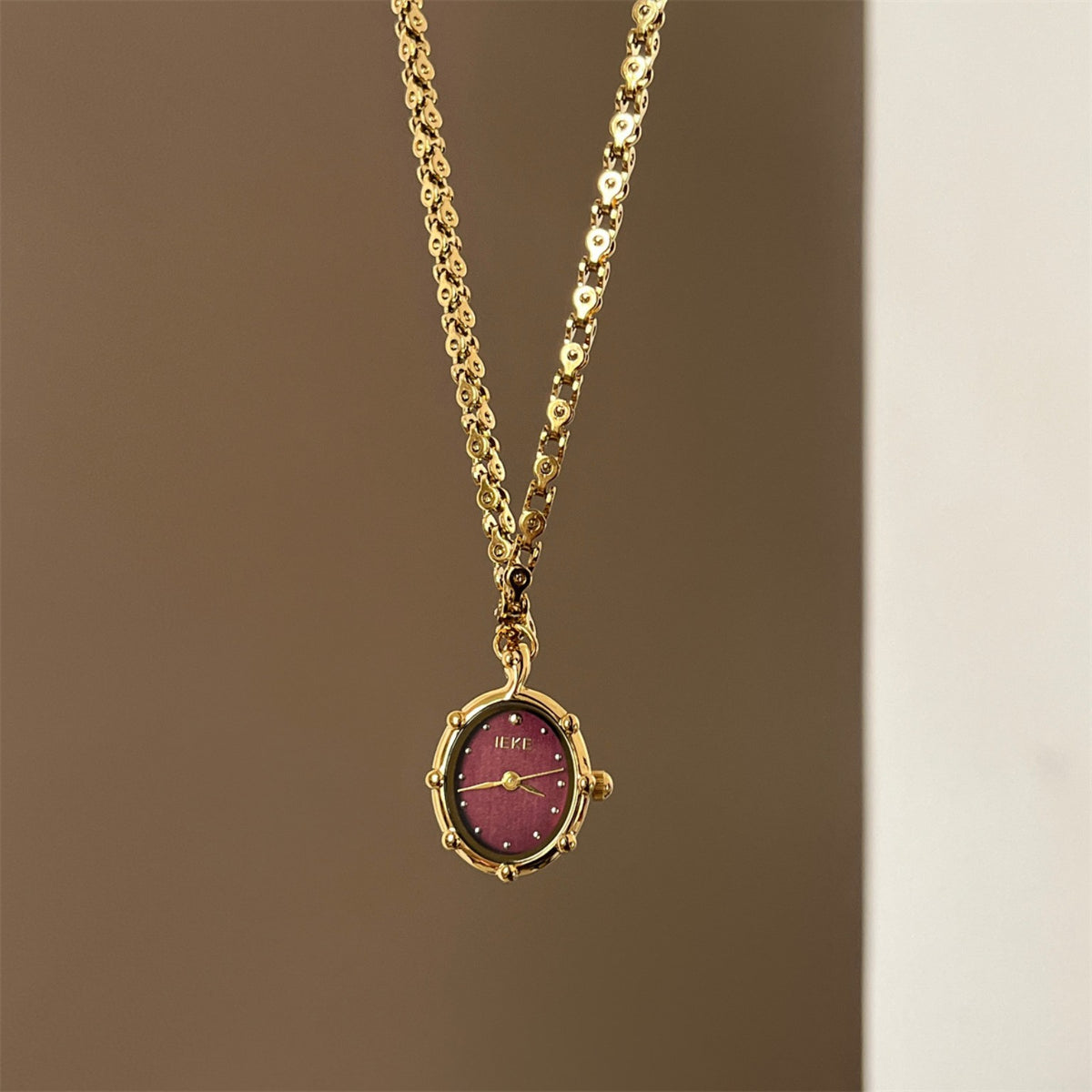 IEKE gold pendant necklace watch with burgundy oval dial