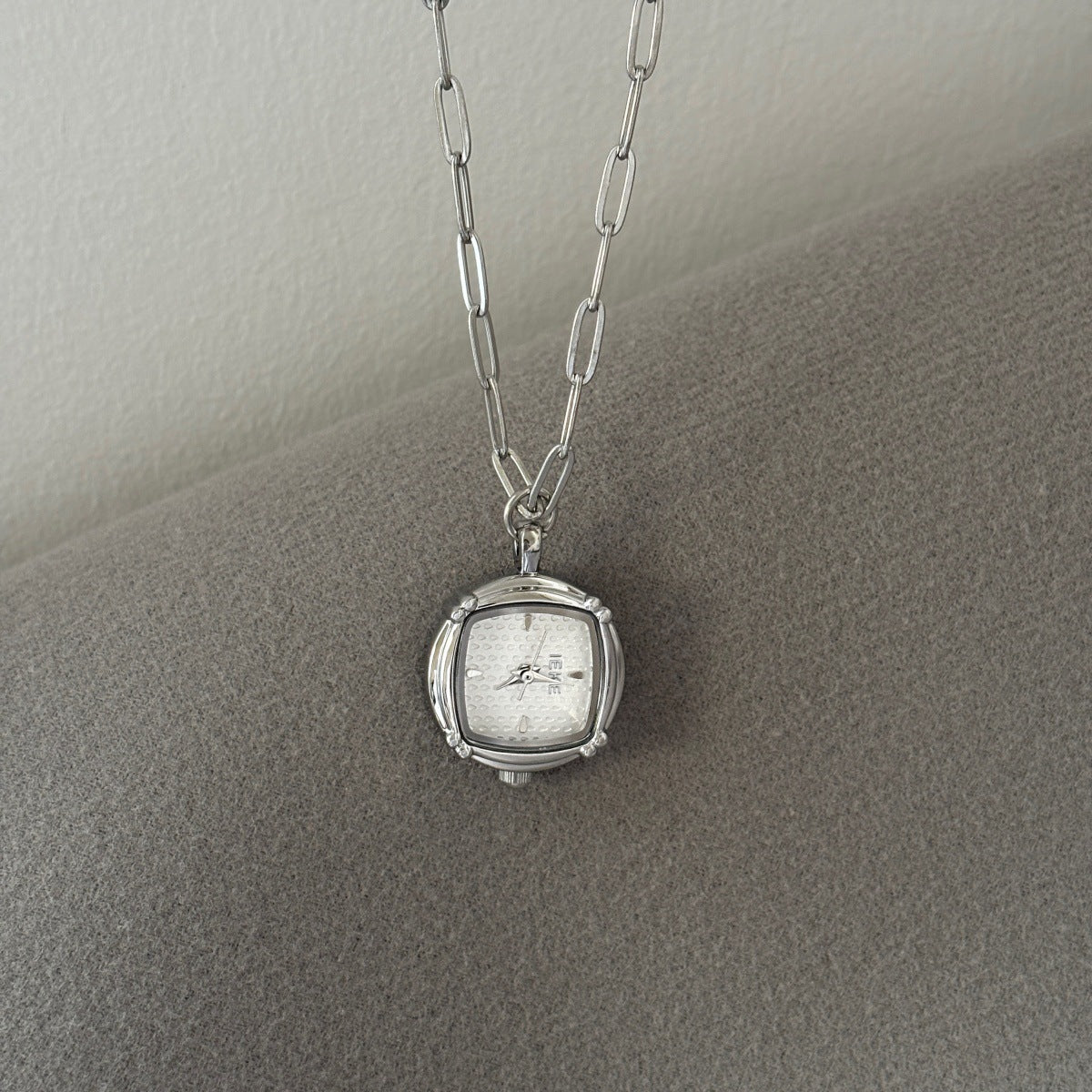 IEKE silver-tone pendant watch light dial detail