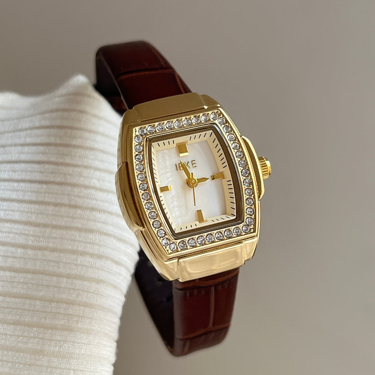 IEKE petite crystal tonneau watch with brown leather-look strap, gold-tone case and white dial