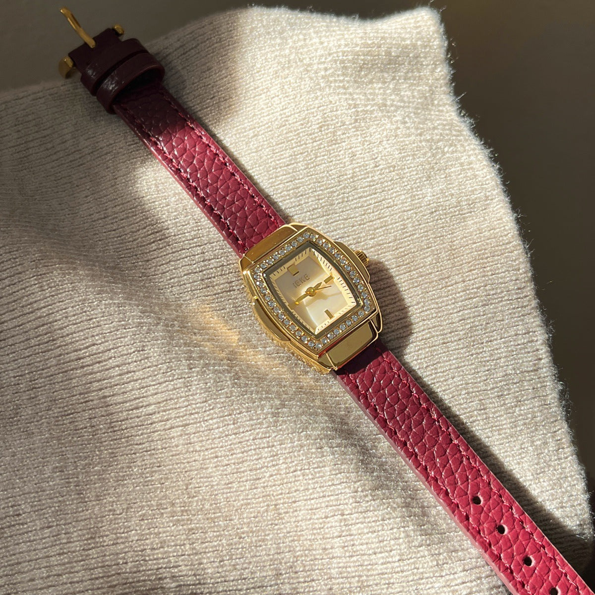 IEKE petite crystal tonneau watch with burgundy leather-look strap, gold-tone case and white dial