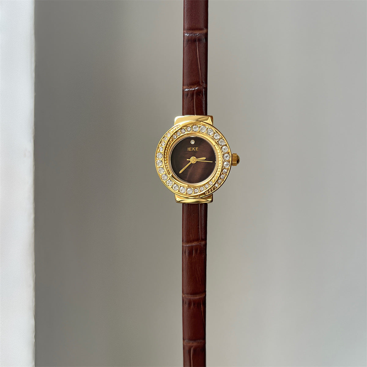 IEKE petite round crystal watch with brown strap, gold-tone case and burgundy dial