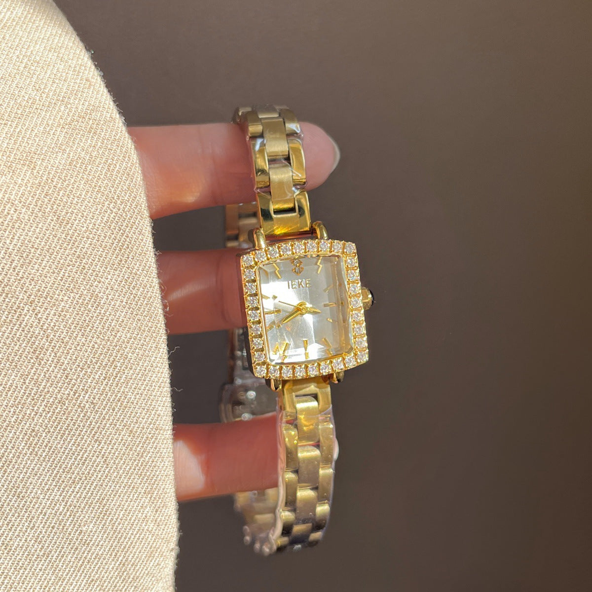 IEKE petite square crystal bezel watch with gold-tone bracelet and white dial