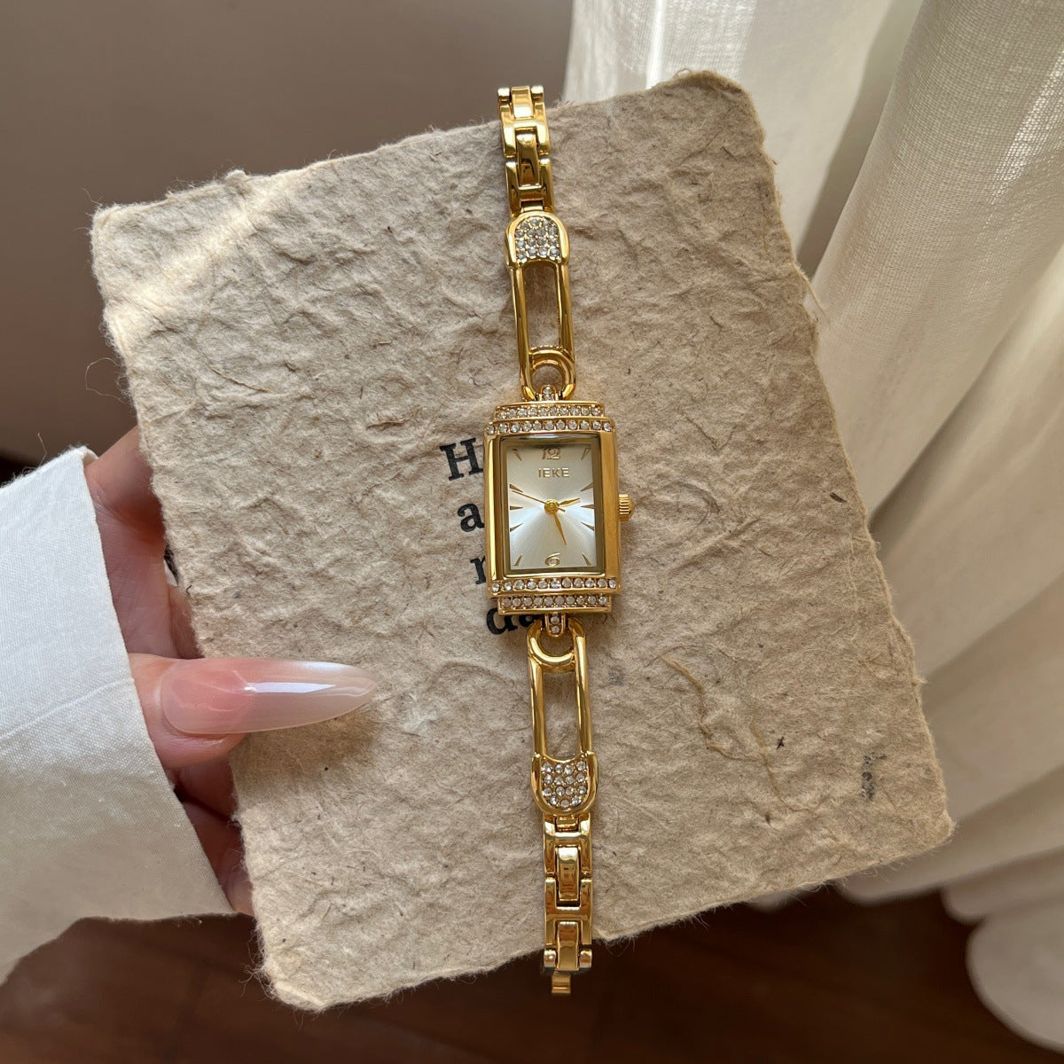 IEKE gold-tone pin-link bracelet watch with white dial