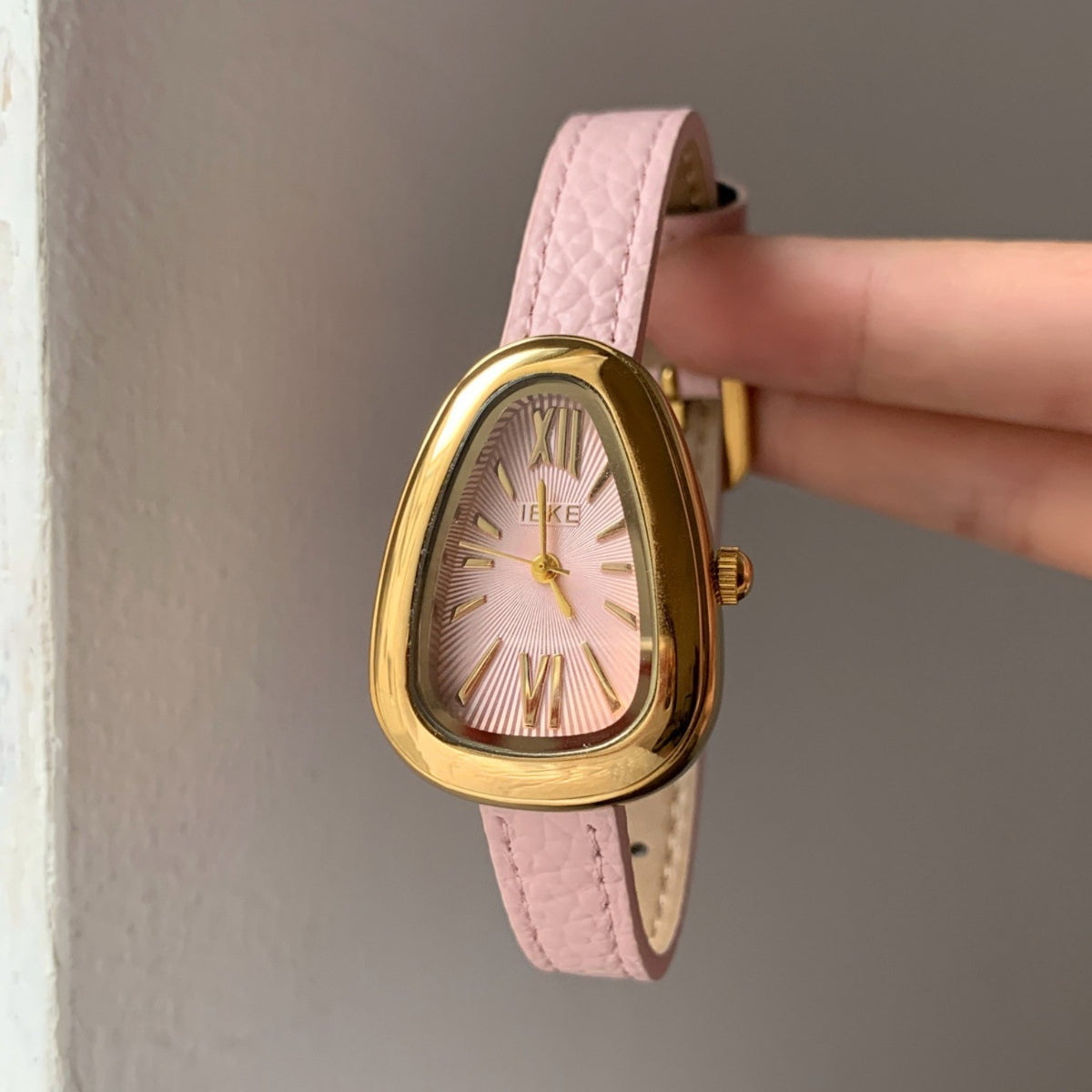 IEKE blush pink sculpted Roman numeral women's quartz watch