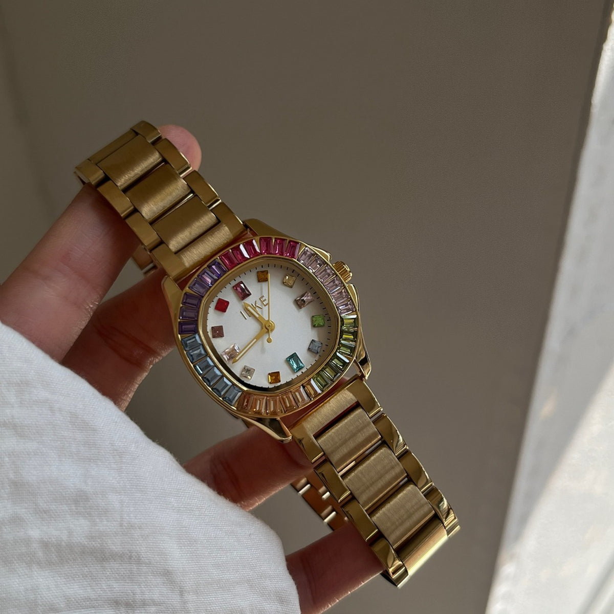 IEKE women's rainbow crystal bracelet watch with gold-tone bracelet and white dial