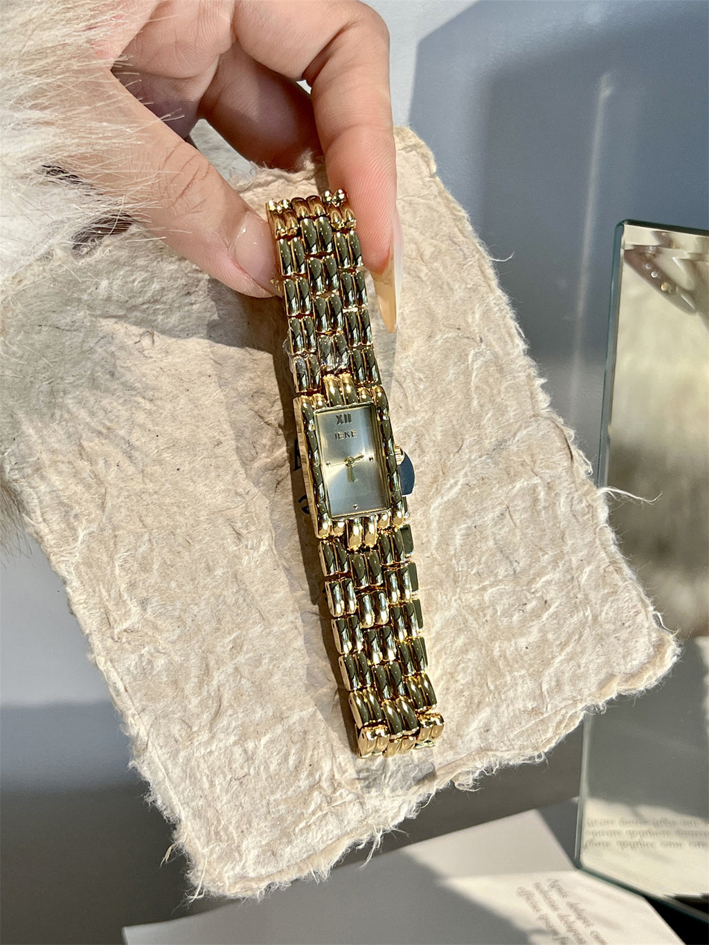 IEKE gold-tone rectangular chain bracelet watch close-up