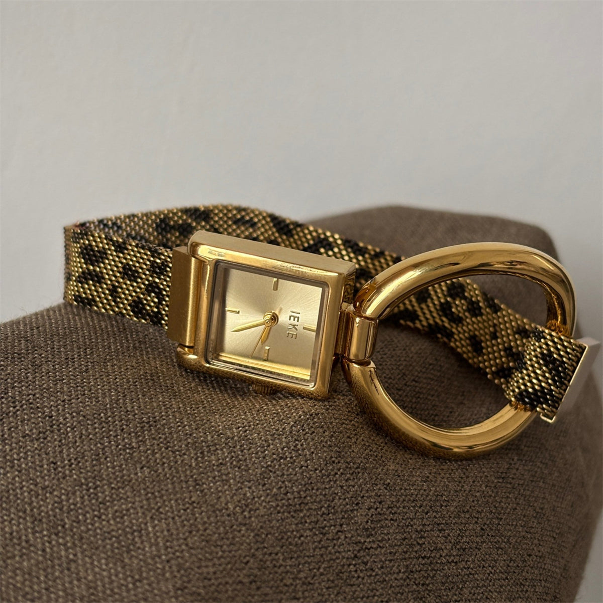 IEKE gold square quartz watch with patterned magnetic mesh strap and oversized ring detail