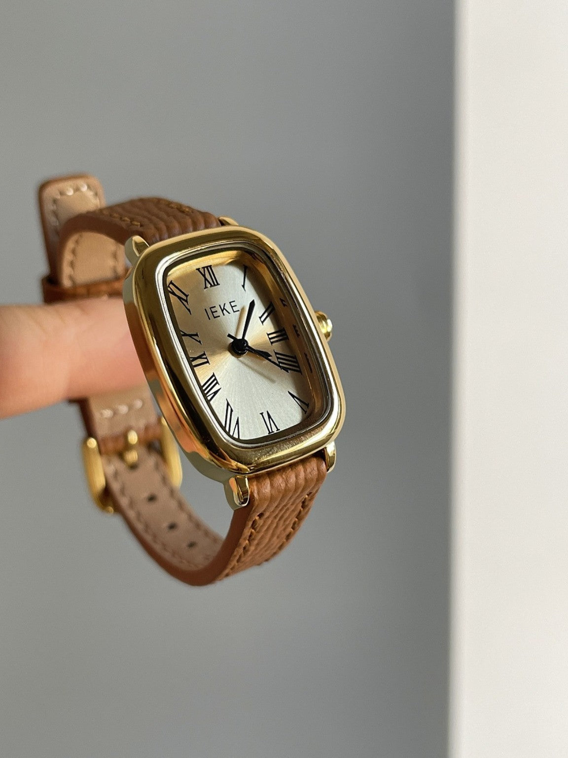 IEKE cushion-shaped Roman numeral women's watch with gold-tone case and brown strap