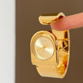 IEKE sculptural cuff bracelet watch in polished gold with gold dial