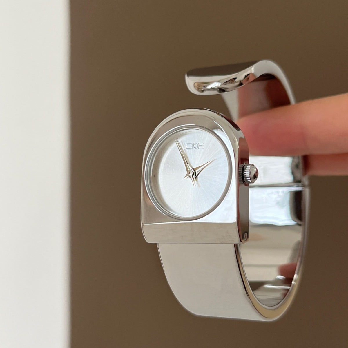 IEKE sculptural cuff bracelet watch in polished silver with silver dial