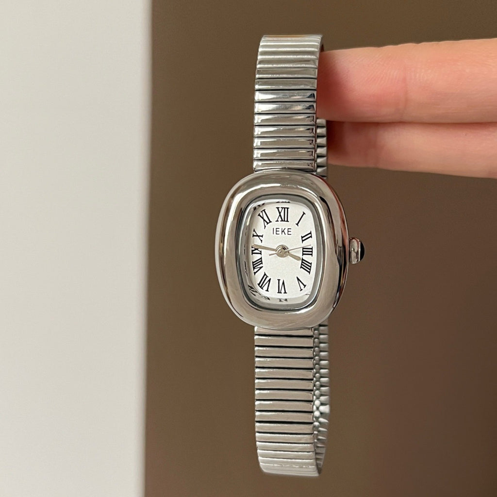 IEKE women's petite oval quartz watch with white Roman numeral dial, silver-tone case and silver expansion bracelet