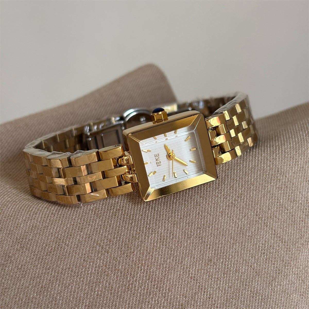 IEKE petite square bracelet watch in gold tone with white dial