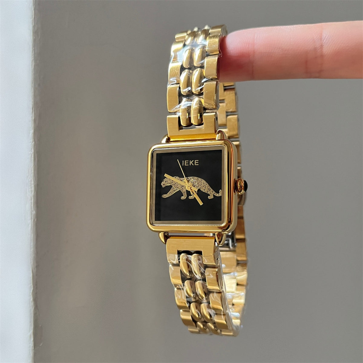 IEKE women's square leopard motif watch with black dial, gold-tone case and two-tone metal bracelet