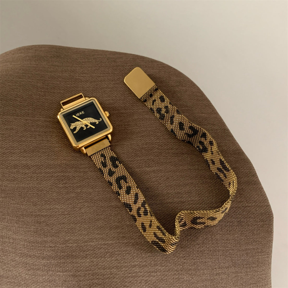 IEKE women's square watch with black dial, gold-tone case and patterned mesh band