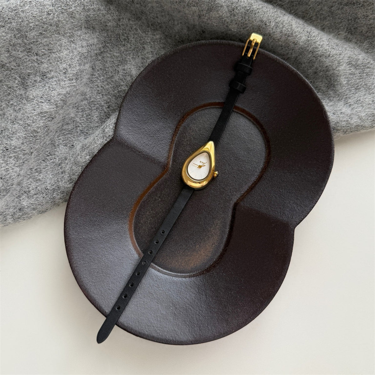 IEKE teardrop women's quartz watch with white dial, black strap and gold-tone case