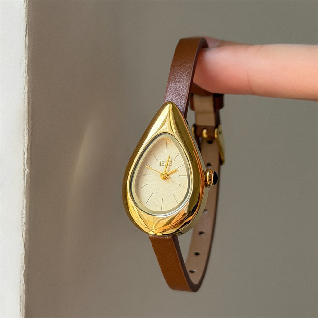 IEKE women's teardrop quartz watch with cream dial, brown strap and gold-tone case shown on wrist
