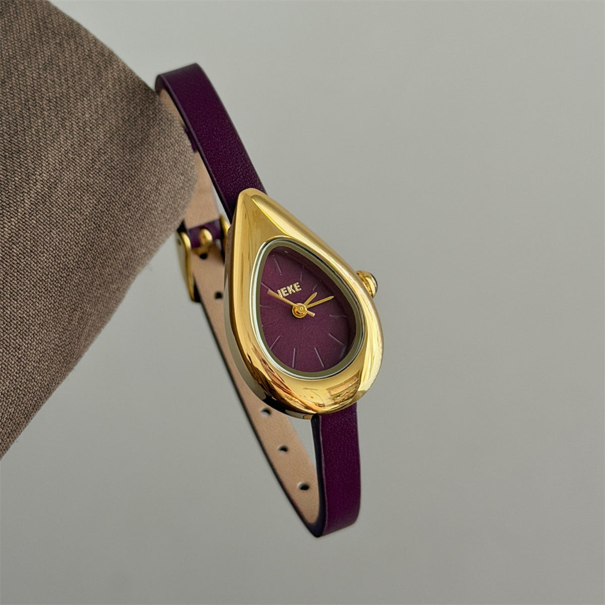 IEKE sculptural teardrop women's watch with burgundy dial, burgundy strap and gold-tone case