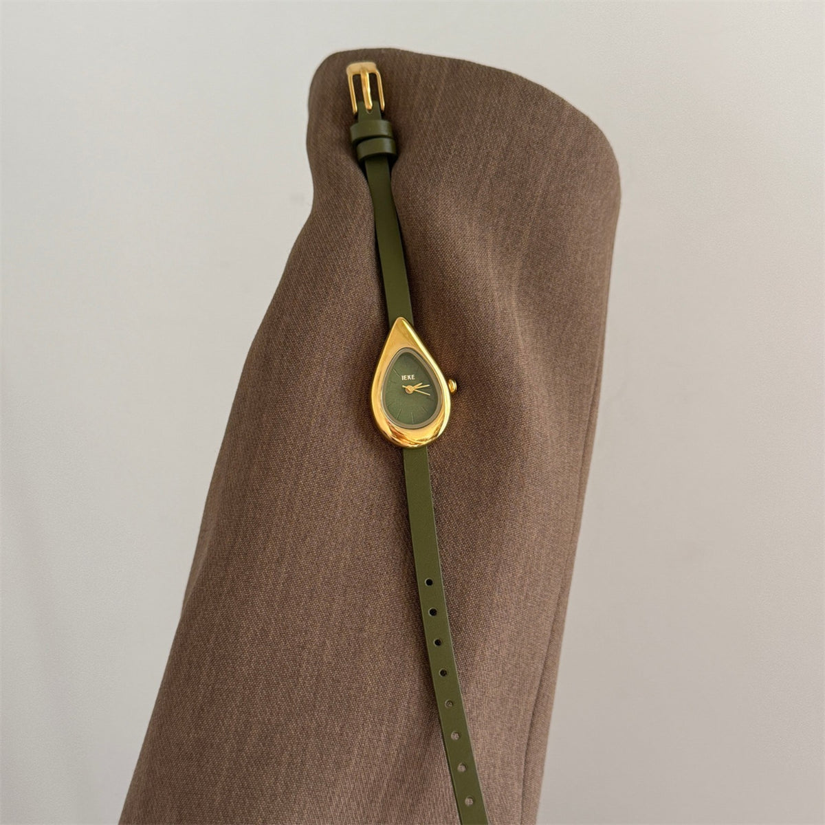 IEKE teardrop women's quartz watch with olive green dial and strap in a gold-tone sculptural case
