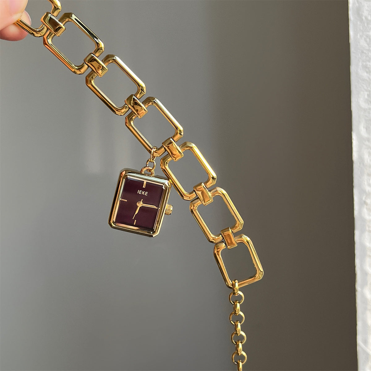 IEKE vintage charm bracelet watch with gold-tone open-link bracelet and burgundy dial