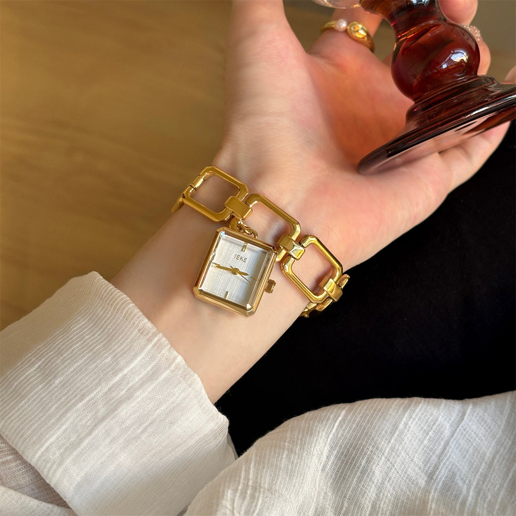 IEKE vintage charm bracelet watch with white dial worn on wrist