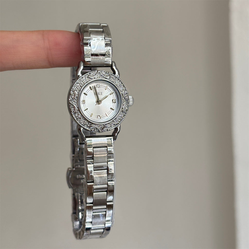 Close-up of IEKE silver-tone petite women's watch with crystal-style markers and ornate vintage bezel