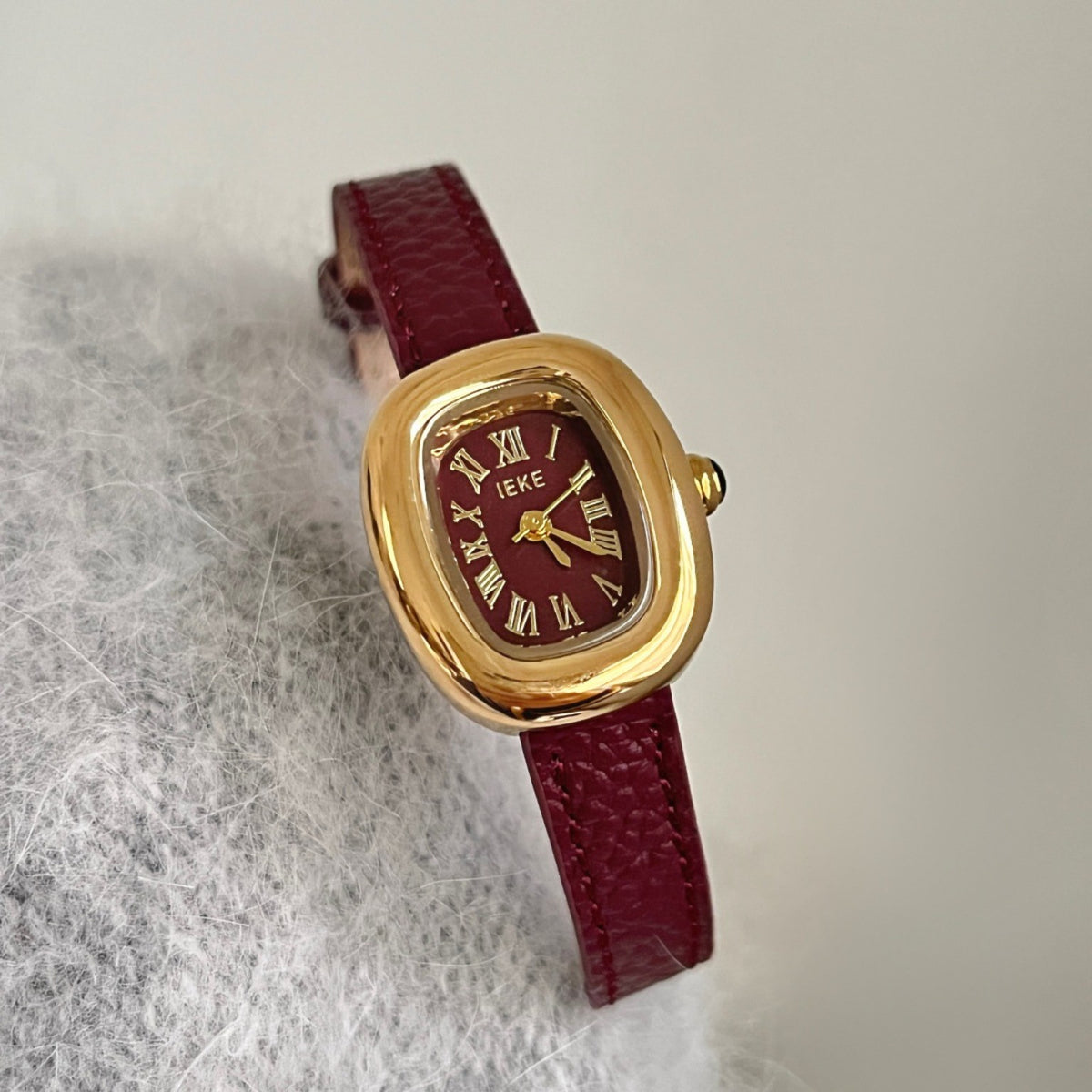 IEKE women's vintage oval quartz watch with burgundy dial, burgundy leather-style strap and gold-tone case