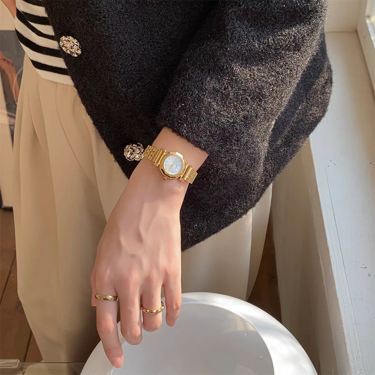 IEKE vintage round gold-tone women's watch with champagne dial styled on wrist