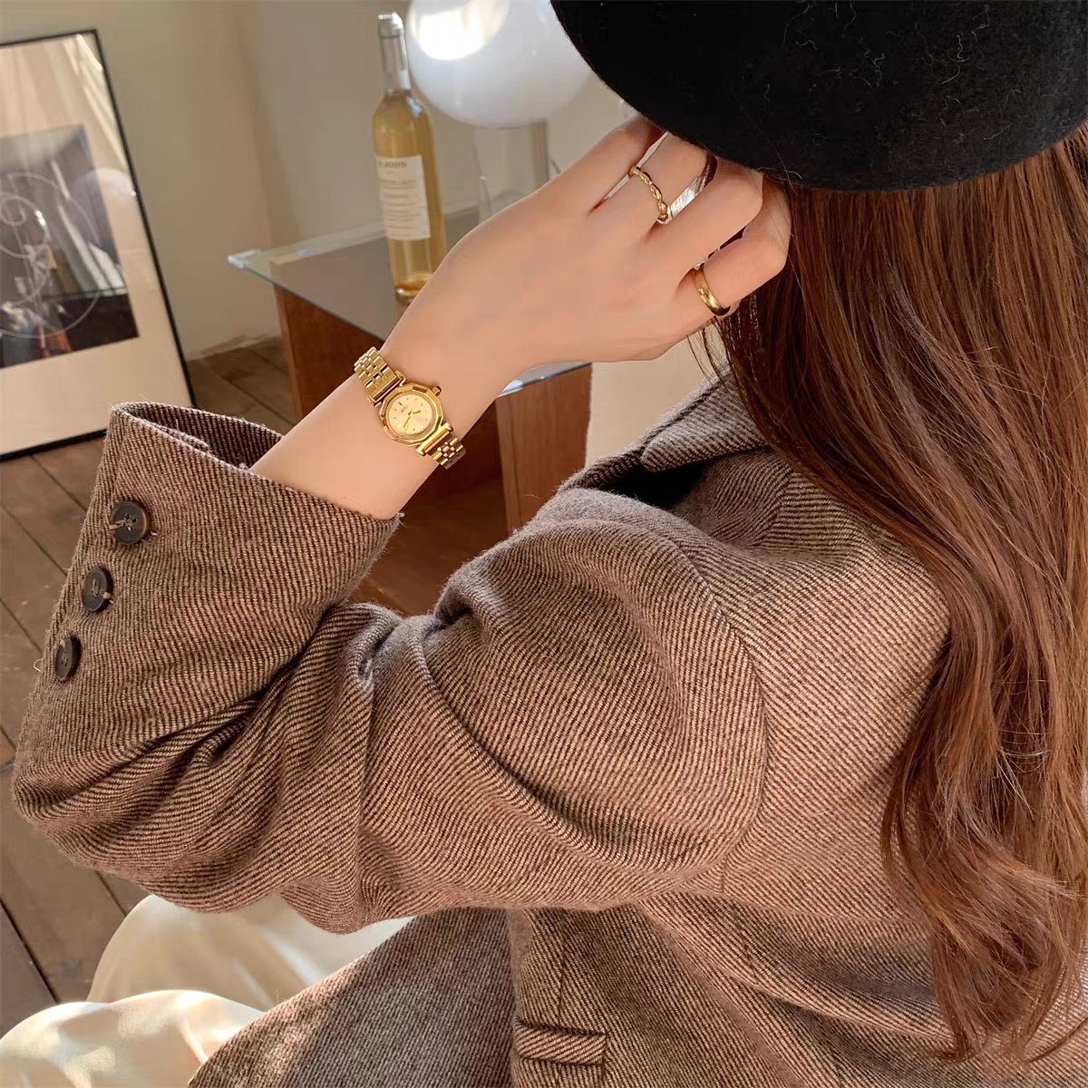 IEKE vintage round gold-tone women's watch styled on wrist