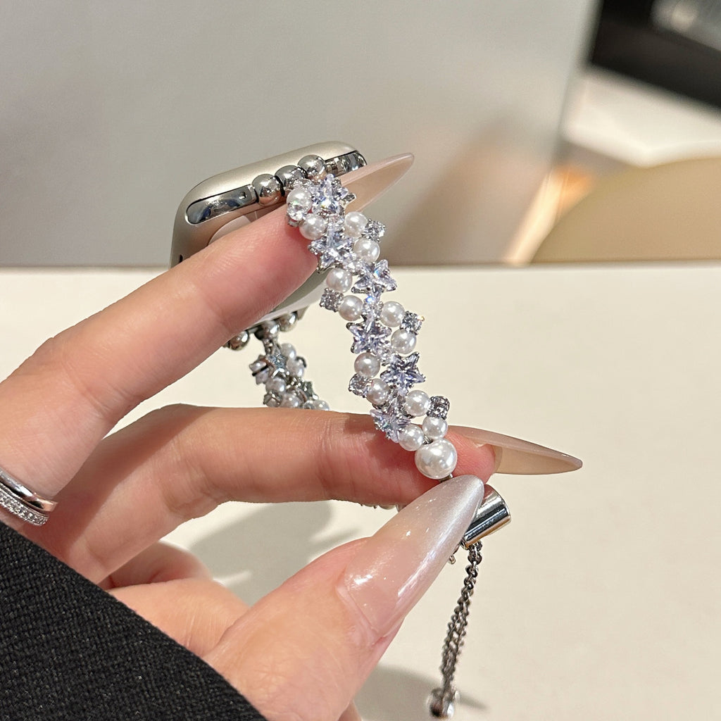 Close-up of silver tone pearl crystal star Apple Watch jewelry band