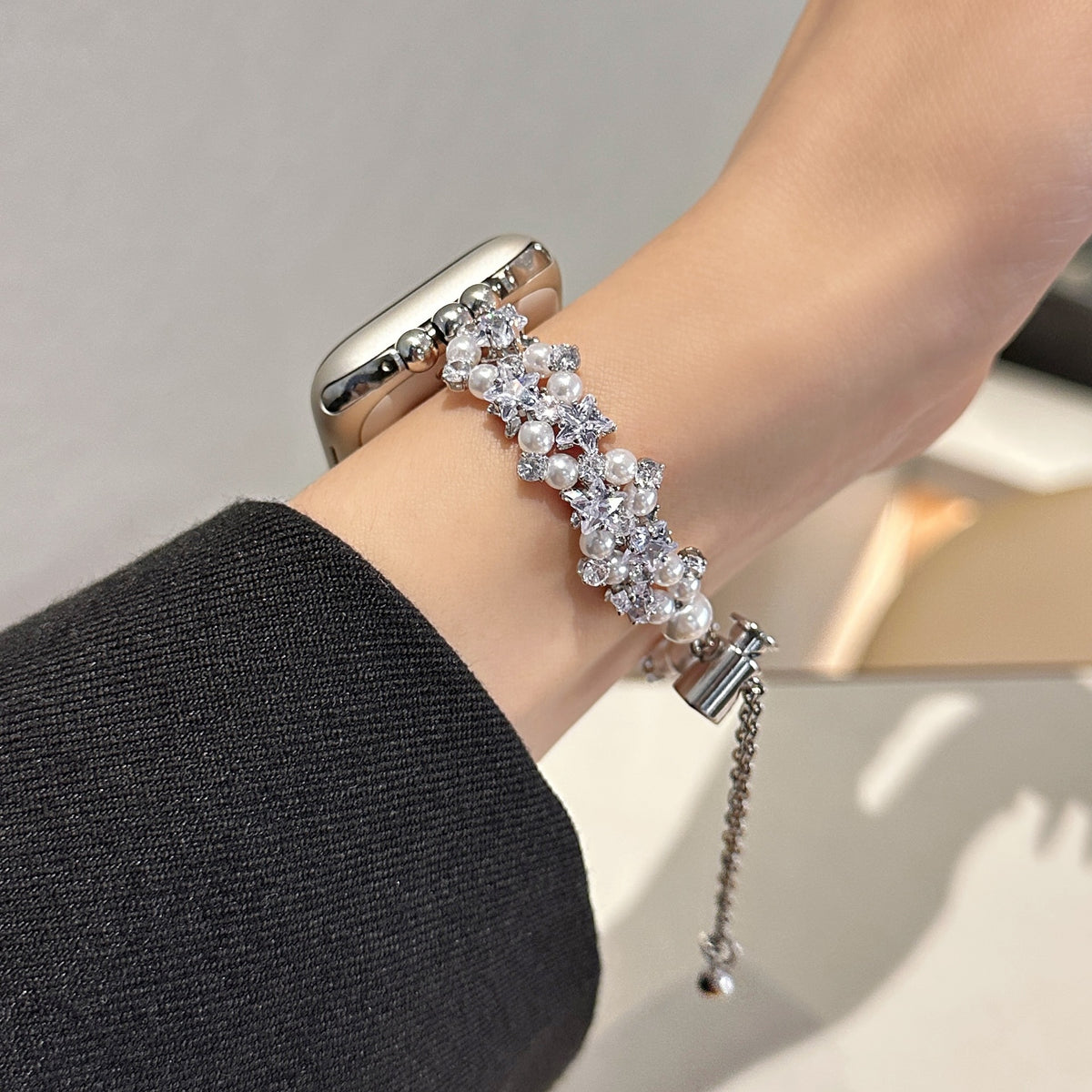 Silver tone pearl and crystal Apple Watch bracelet band worn on wrist