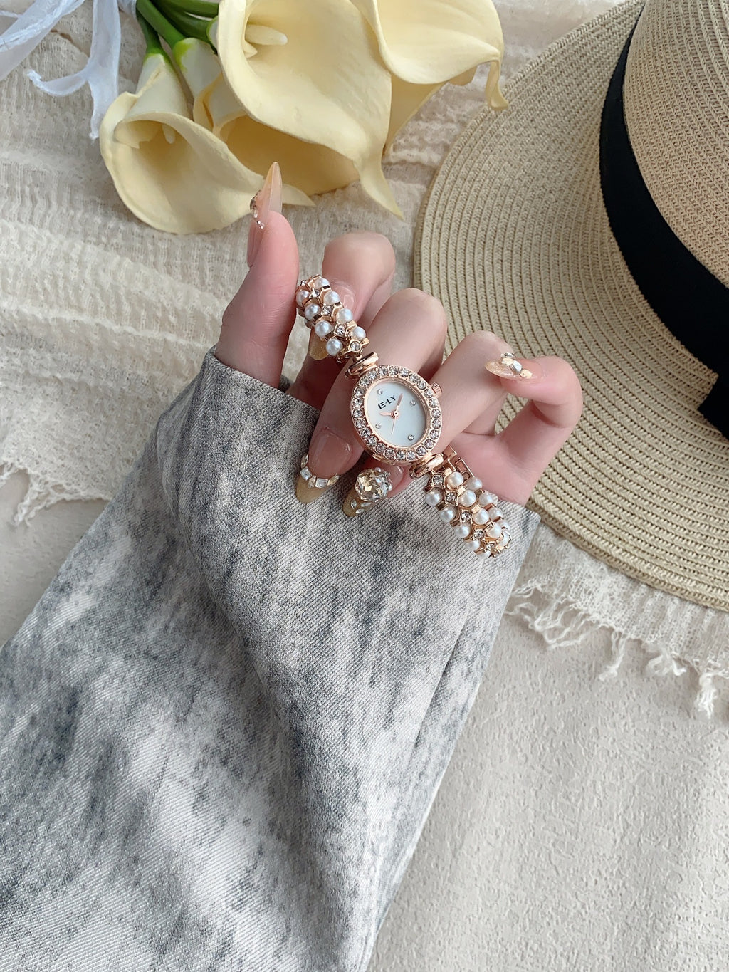ISLY pearl crystal-style oval bracelet watch in rose gold tone hand view