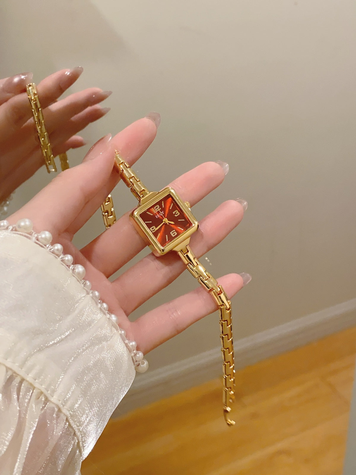 ISLY gold-tone square bracelet watch with red dial