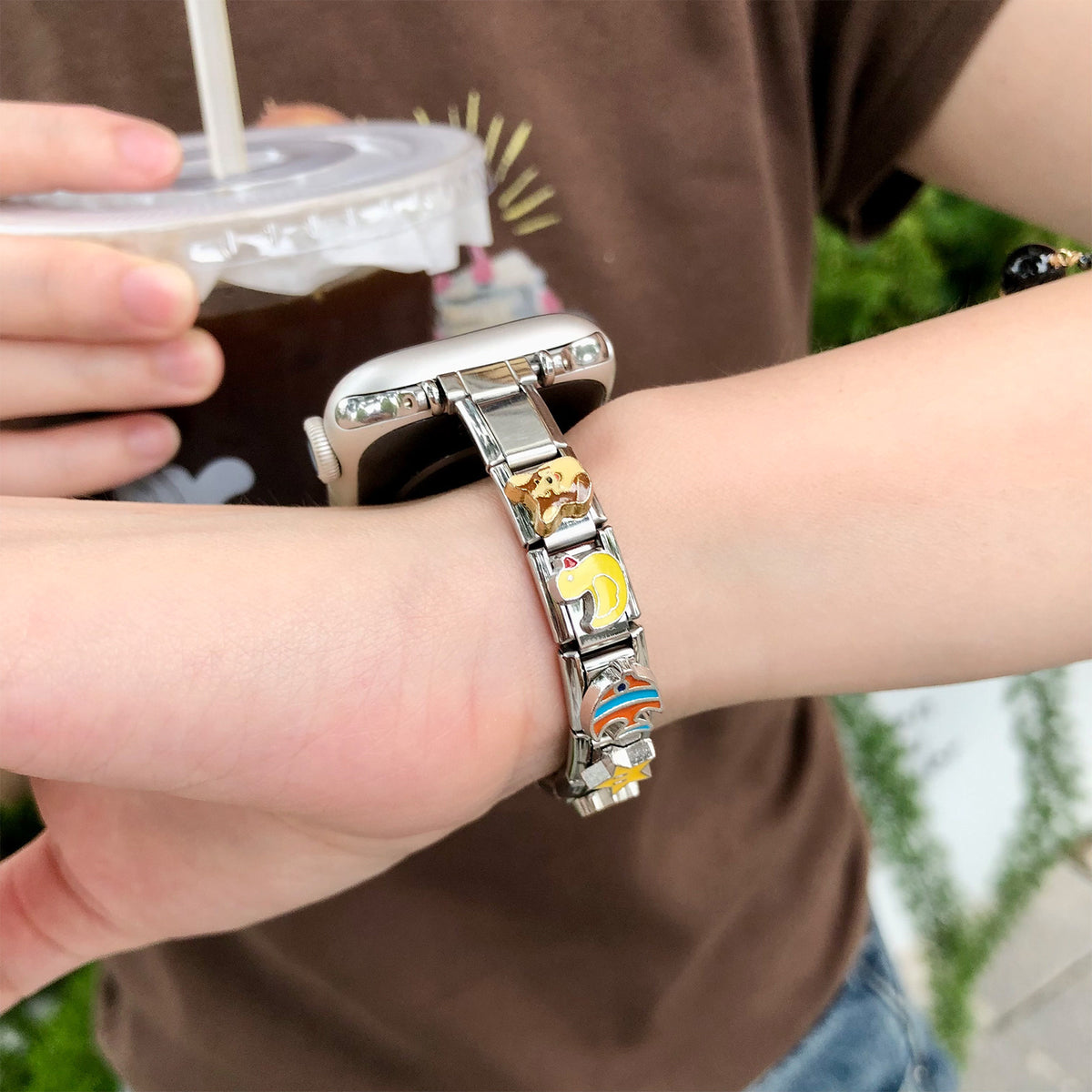 Colourful stainless steel modular charm smartwatch band worn on wrist