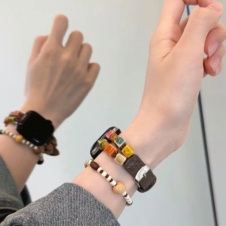 Brown mosaic bead leather Apple Watch band worn on wrist