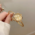 NAIDU braided cable bangle watch in gold tone with champagne dial