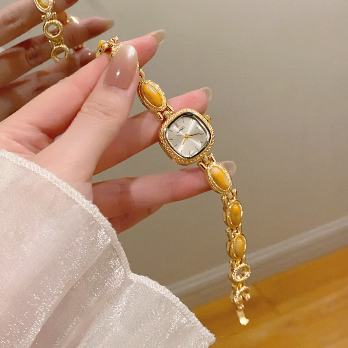 NAIDU cabochon-style jewelry watch with amber accents