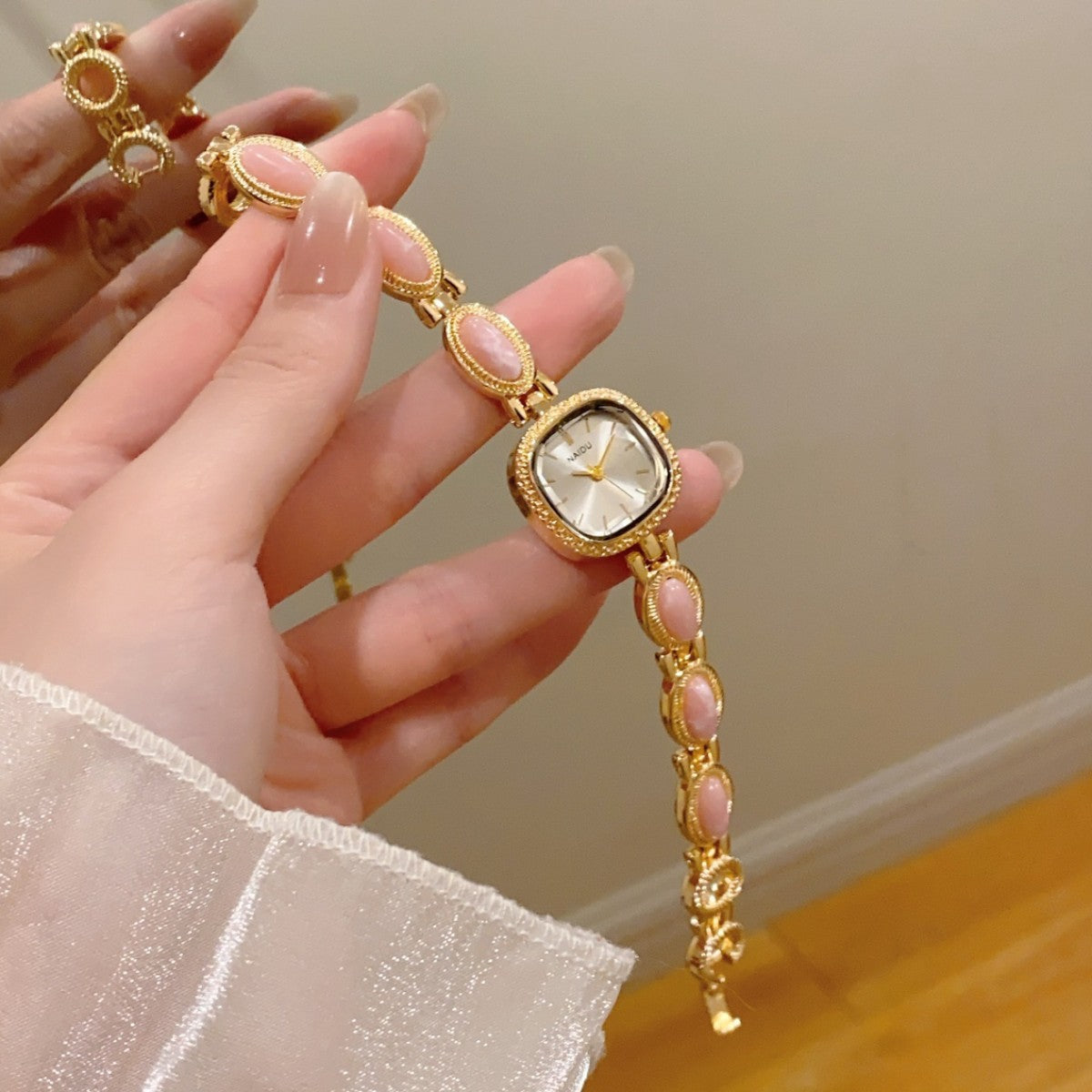 NAIDU cabochon-style jewelry watch with pink accents