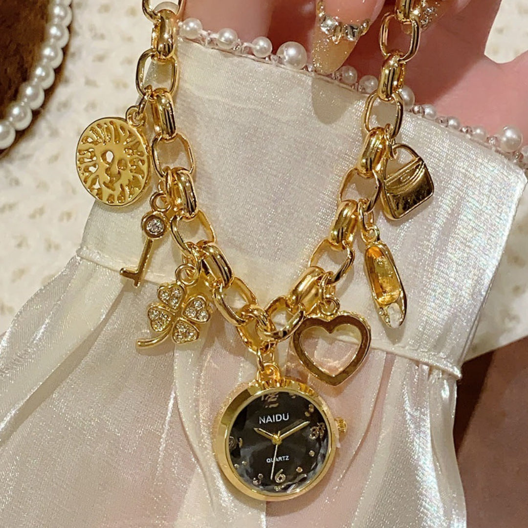 NAIDU charm bracelet watch in gold tone with black dial