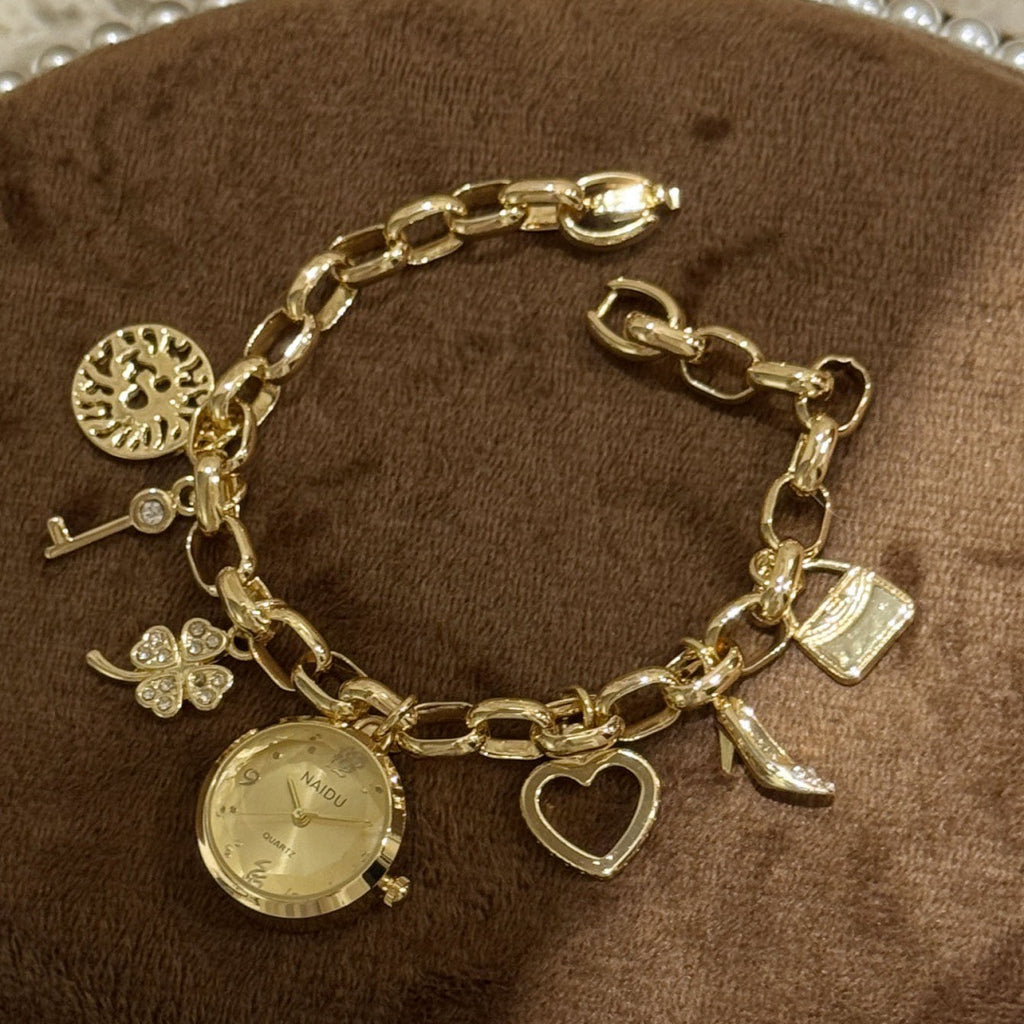 NAIDU charm bracelet watch in gold tone with champagne dial