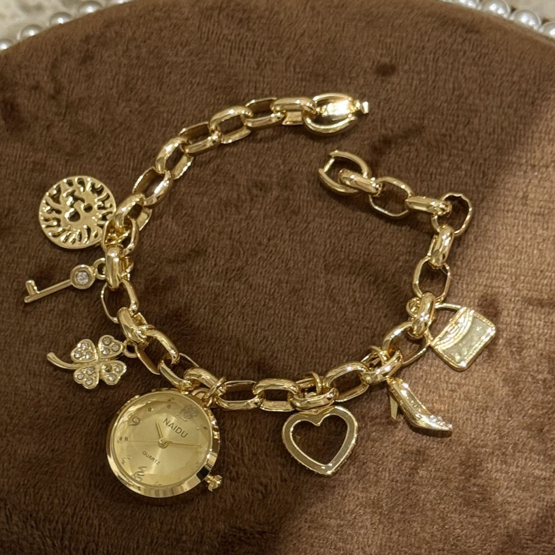 NAIDU charm bracelet watch in gold tone with champagne dial