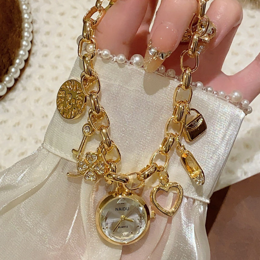 NAIDU charm bracelet watch in gold tone with white dial hand view