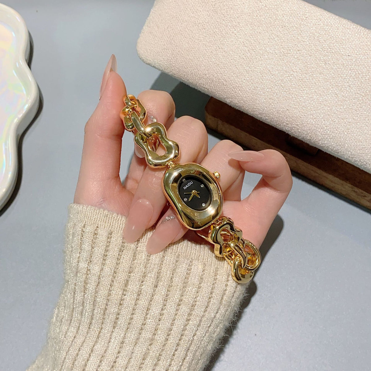 NAIDU sculpted-link jewelry watch in gold tone with black dial