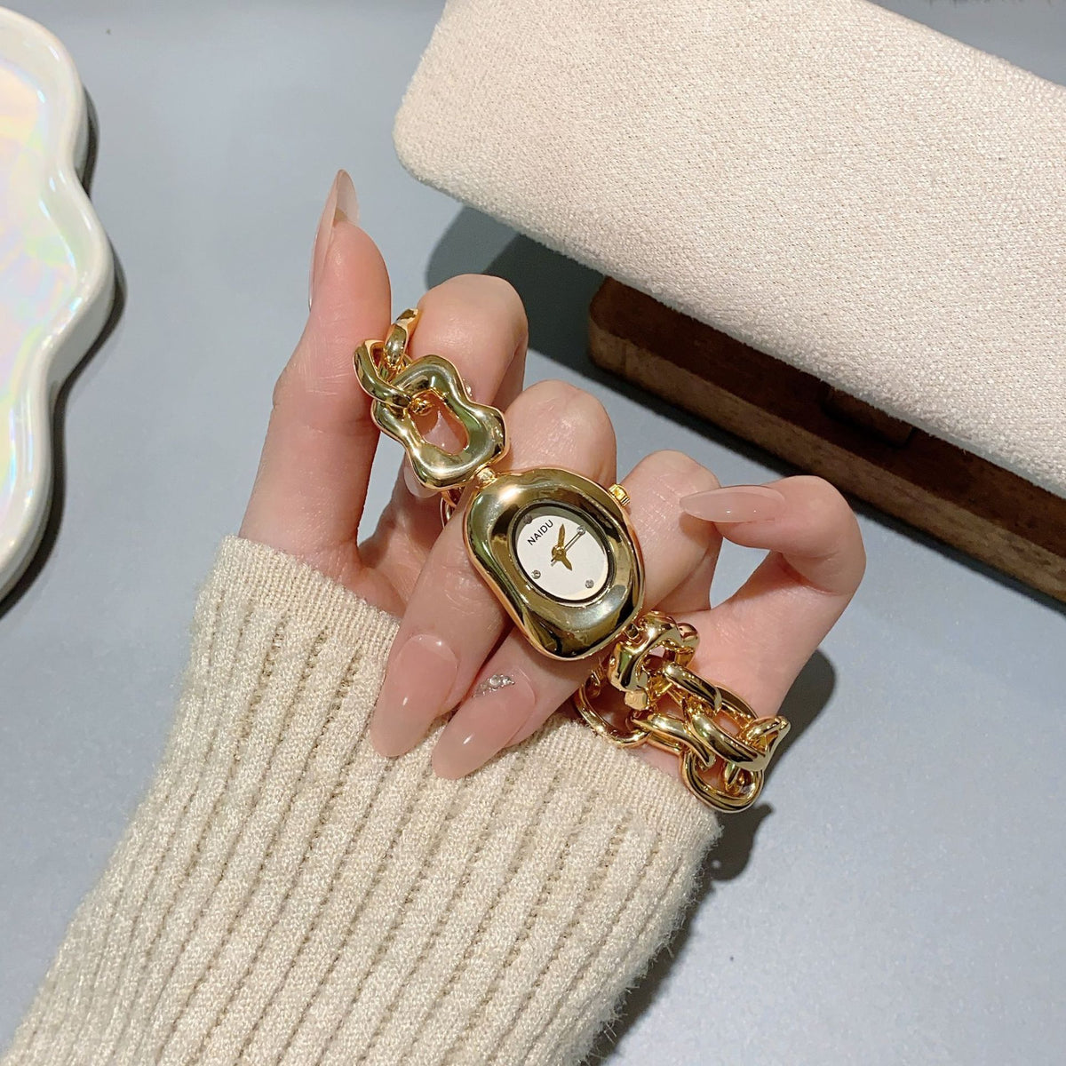NAIDU sculpted-link jewelry watch in gold tone with white dial