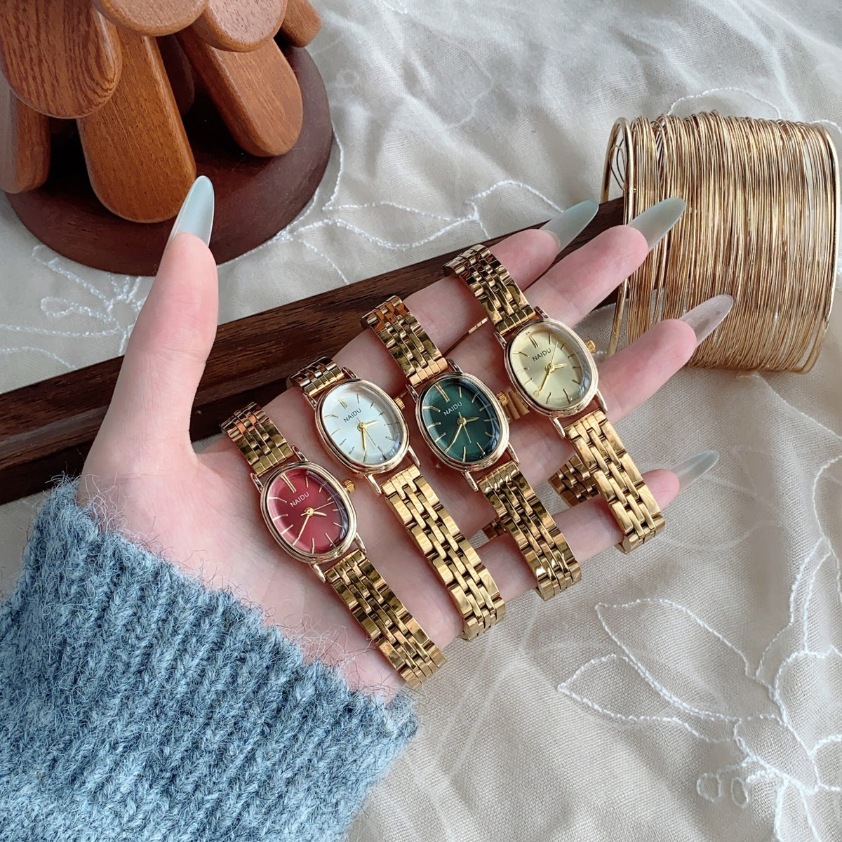 NAIDU vintage gold-tone steel bracelet quartz watch collection with red, white, green and champagne dials