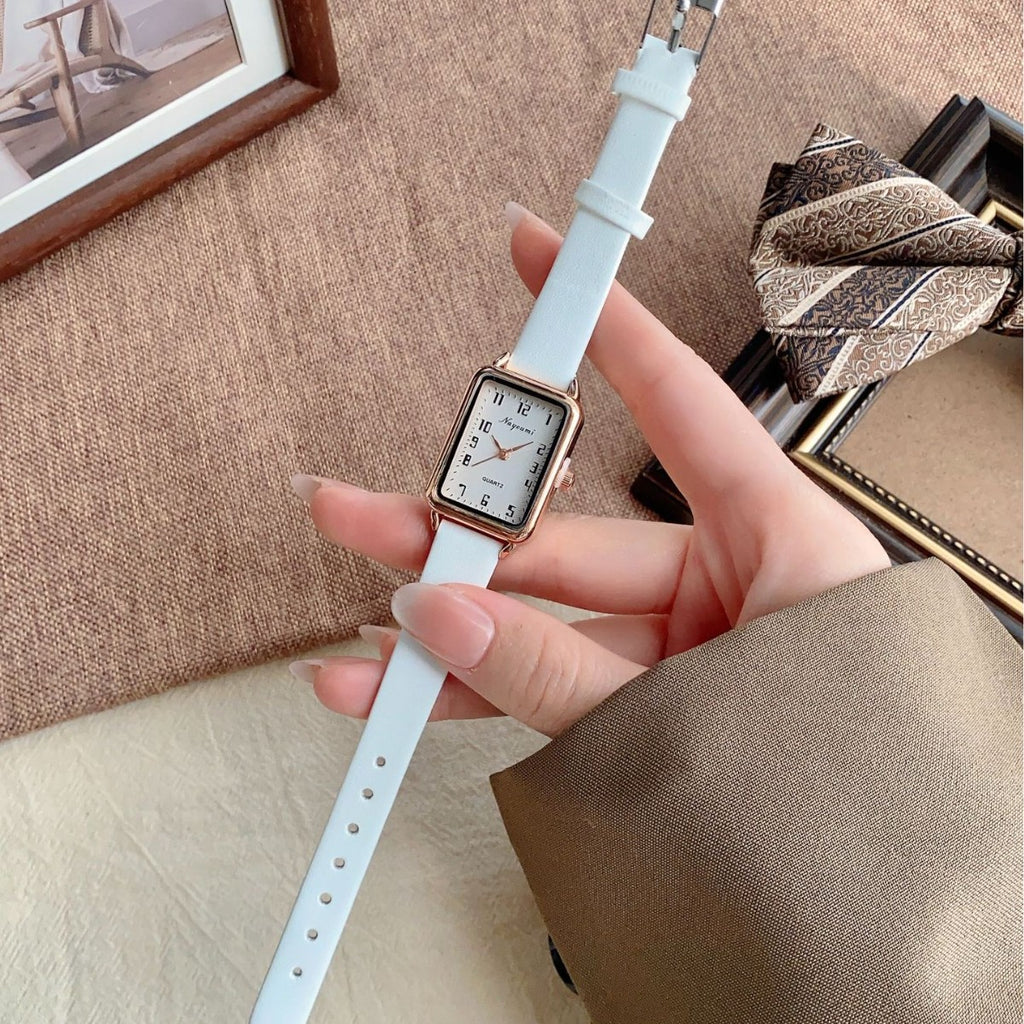Vintage gold rectangle women's watch with white strap lifestyle view