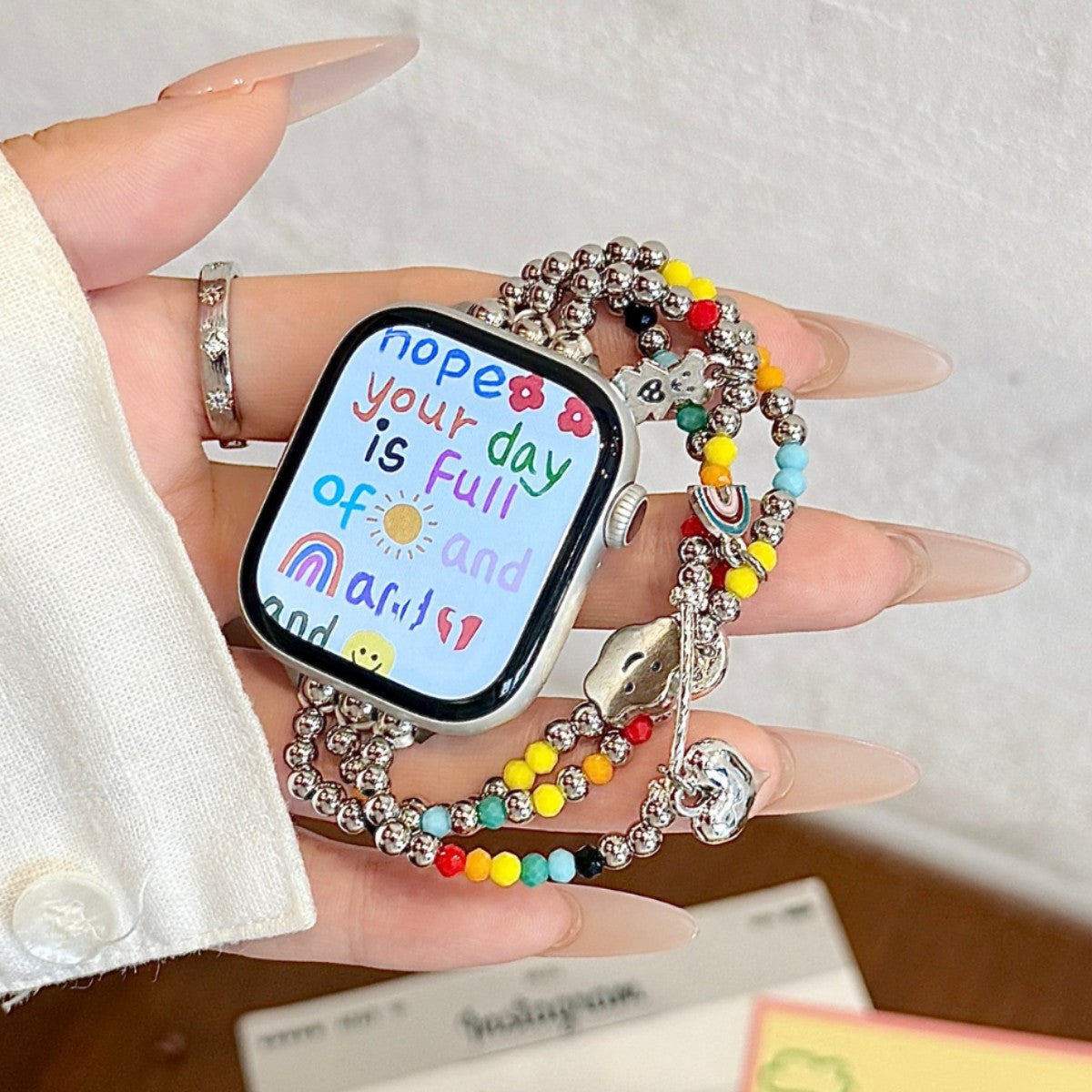 Rainbow candy multi-strand Apple Watch band in hand
